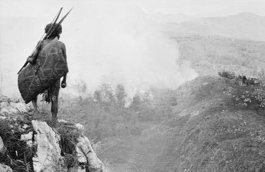 Burning houses and victorious natives, Papua New Guinea, ca. 1930s / Michael Leahy