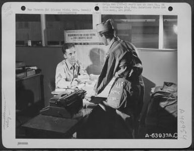 Two Gis Discuss Overseas Votes For The National Election. Hickam Field, Oahu, Hawaii, 9 September 1944. (U.S. Air Force Number A63937AC)