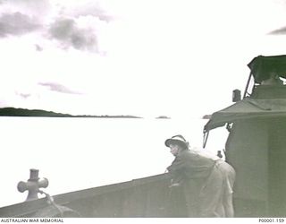 THE SOLOMON ISLANDS, 1945-05. TWO AUSTRALIAN SOLDIERS AT SEA ON BOARD AN ARMY VESSEL OFF NORTH BOUGAINVILLE. (RNZAF OFFICIAL PHOTOGRAPH.)