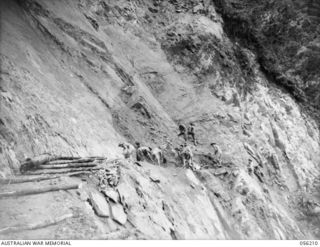 REINHOLD HIGHWAY, NEW GUINEA. 1943-08-22. ROCK FACE, THREE TO FOUR MILES ON THE BULLDOG SIDE OF JOHNSON'S GAP BEING WORKED BY SAPPERS ON THE 9TH AUSTRALIAN FIELD COMPANY, ROYAL AUSTRALIAN ENGINEERS