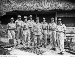 VX1 General Sir Thomas Blamey GBE KCB CMG DSO ED, Commander in Chief, Allied Land Forces, South West Pacific Area, photographed with some of his officers outside his hut. They are: NX13710 Captain ..