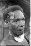 Man with dafi pearshell neck ornament, and plaited fari (spilt) comb with kwaloi'a porpoise tooth star, and leaf bespelled to protect him from sorcery at the feast