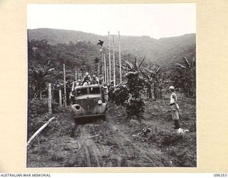 KAIRIRU ISLAND, NEW GUINEA, 1945-09-08. JAPANESE TRUCK ARRIVING WITH LOADING PARTY TO TAKE OFFICERS OF HQ 6 DIVISION TO THE WEAPON DUMP. THE WEAPONS WILL BE GATHERED FOR REMOVAL TO DIVISIONAL HQ AT ..