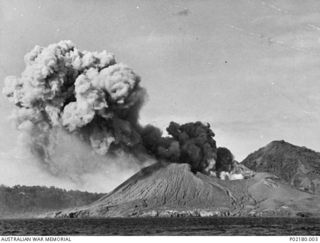 Rabaul, New Britain. 1941-06. Aerial photograph of smoke billowing from the active Matupi volcano following its eruption. Matupi erupted in 1937 causing a loss of 600 lives and the eruption in 1941 ..