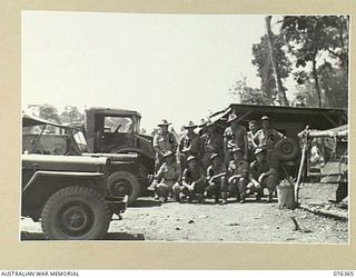 LAE, NEW GUINEA. 1944-10-03. TRANSPORT SECTION PERSONNEL OF HEADQUARTERS, 6TH INFANTRY BRIGADE AT THE UNIT BUTIBUM ROAD CAMP. IDENTIFIED PERSONNEL ARE:- VX103977 PRIVATE J. TATTERSALL (1); VX103983 ..