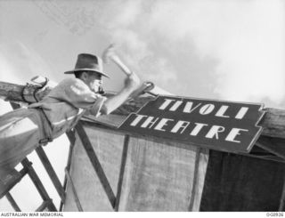 NADZAB, NEW GUINEA. C. 1944-02. DIVE BOMBER BOYS OF NO. 24 SQUADRON RAAF ADOPT TIVOLI GIRL PERFORMERS AND THERE'S A TIVOLI THEATRE ON THE JUNGLE FRONT. LEADING AIRCRAFTMAN P. SIBLEY OF WHINGHAM, ..