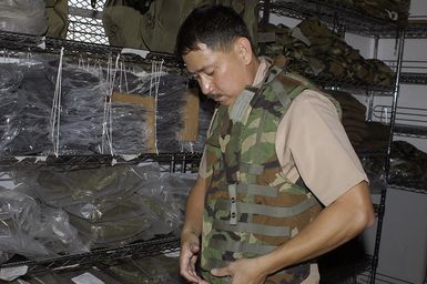 US Navy (USN) CHIEF Hospital Corpsman (HMC) Alberto Redublo, Naval Environmental and Preventive Medicine Unit 6 (NEPMU-6) inspects a vest he will need for deployment to Indonesia. NEPMU-6 is deploying to Indonesia to provide humanitarian support and conduct water quality testing, insect collection and examination for disease, and medical assistance as part of Tsunami Humanitarian Disaster Relief Effort following the 9.0 Tsunami event on December 26, 2004