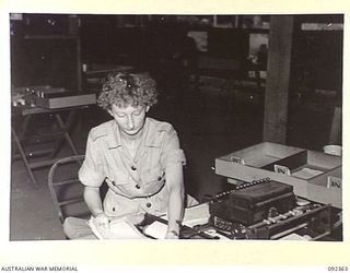 LAE, NEW GUINEA, 1945-05-23. PRIVATE B.M. SHUTE, AWAS (1), PREPARING VOUCHERS AT NO 2 SUB DEPOT, 4 ADVANCED ORDNANCE DEPOT. AWAS PERSONNEL ARE AT LAE TO RELEASE MEN OF HQ FIRST ARMY FOR DUTY IN ..