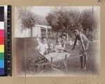 Children in wheelbarrow, Delena, Papua New Guinea, ca. 1905-1915