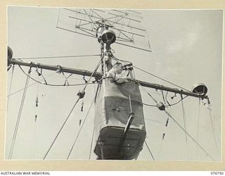 LANGEMAK BAY, NEW GUINEA. 1944-10-23. A RATING ON THE LOOK-OUT FROM THE CROWS NEST OF THE RAN CORVETTE GYMPIE