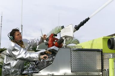 Right side front view medium shot as US Air Force SENIOR MASTER Sergeant Tim Bosch, Deputy Fire CHIEF, Hickam Ai Force Base, Hawaii, demonstrates engineer operations on a P24 Structural fire fighting vehicle. SMSGT Bosch was selected as one of the United States Air Force 12 Oustanding Airmen for 1999