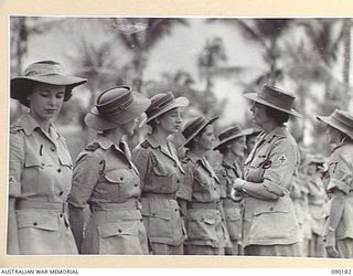 JACQUINOT BAY, NEW BRITAIN. 1945-03-29. LADY WAKEHURST (6), ACCOMPANIED BY MATRON M. WHEELER (7), SPEAKING WITH 2/8 GENERAL HOSPITAL SISTERS OF THE AUSTRALIAN ARMY NURSING SERVICE DURING HER VISIT ..