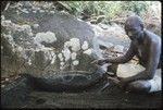 Man pointing at rock drawing