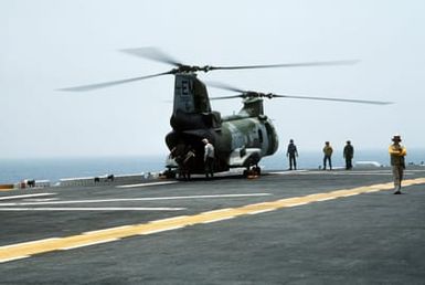 Marines of the 22nd Marine Expeditionary Unit (22nd MEU) board a CH-46E Sea Knight helicopter from Marine Medium Helicopter Squadron 261 (HMM-261) on the flight deck of the amphibious assault ship USS SAIPAN (LHA-2) during Operation Sharp Edge. The Marines will be flown to the U.S. Embassy in Monrovia, Liberia, to augment security and evacuate U.S. and foreign nationals from the fighting between government and rebel forces