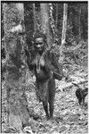 Korumbun: woman in grass skirt carries netbag