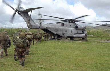 US Army (USA) Soldiers from the 2nd Battalion, 27th Infantry Regiment (2/27) Charlie Company, 25th Infantry Division (ID) [Light], Schofield Barracks, Hawaii (HI), board a US Marine Corps (USMC) CH-53 Sea Stallion helicopter, Marine Medium Helicopter Squadron-263 (HMM-263) at Polaris Point Guam Naval Station for transport to Tinian Island. This is part of an Airborne Insert onto an island during Exercise TANDEM THRUST 2003