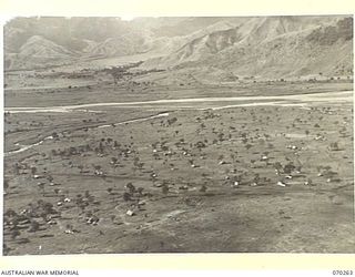 DUMPU, RAMU VALLEY, NEW GUINEA, 1944-02-10. AN AERIAL VIEW TAKEN AT 300 FEET OF 7TH DIVISION SIGNAL HEADQUARTERS, LOOKING SOUTH ACROSS THE URIA AND RAMU RIVERS