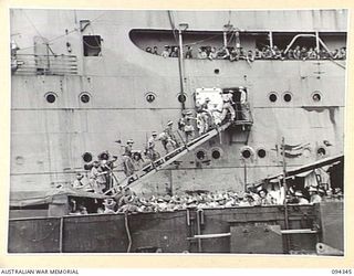 TOROKINA, BOUGAINVILLE. 1945-07-26. THE FIRST CONTINGENT OF "FIVE YEAR RELEASE PERSONNEL" TO LEAVE FOR THE RETURN TO AUSTRALIA. THE MEN, WHO HAVE COMPLETED FIVE YEARS IN THE ARMY, ARE BOARDING THE ..