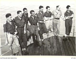 MILNE BAY, PAPUA, 1944-03-04. MEMBERS OF THE MILITARY HISTORY SECTION PICTURED ABOARD THE H.T. TAROONA ON ARRIVAL AT MILNE BAY FROM TOWNSVILLE, QUEENSLAND. IDENTIFIED PERSONNEL ARE: NX191007 ..