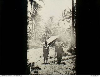 Bitapaka, New Britain. 1915-08-24. A RAN member of the Australian Naval and Military Expeditionary Force (AN&MEF) and an (indigenous) New Briton native stand as sentry at one of the three defensive ..