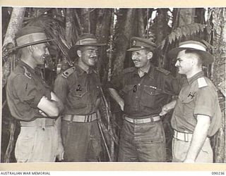 BOUGAINVILLE. 1945-04-03. BRIGADIER H.H. HAMMER, COMMANDER 15 INFANTRY BRIGADE (3), AND SOME OF HIS OFFICERS AT HEADQUARTERS 15 INFANTRY BRIGADE. IDENTIFIED PERSONNEL ARE:- CAPTAIN F.D. WRAY (1); ..