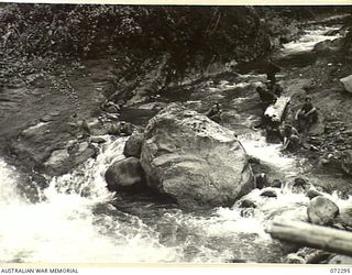 YAULA, NEW GUINEA. 1944-04-10. MEMBERS OF THE 57/60TH INFANTRY BATTALION DRINK WATER FROM THE KOFEBI RIVER AFTER CARRYING SUPPLIES FOR FOUR HOURS TO FORWARD POSITIONS