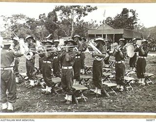 NEW GUINEA. 1943-11-20. THE BAND OF THE 18TH AUSTRALIAN INFANTRY BRIGADE, WHICH PLAYED THROUGHOUT THE SPORTS MEETING WHICH WAS HELD TO CELEBRATE THE FOURTH ANNIVERSARY OF THE FORMATION OF THE UNIT