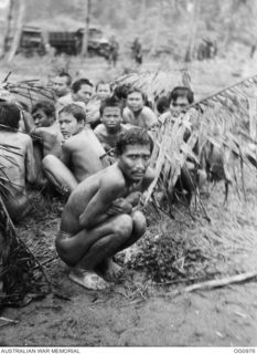 AITAPE AREA, NORTH EAST NEW GUINEA. C. 1944-04. NAKED JAPANESE PRISONERS OF WAR (POWS) CROUCH TOGETHER ON THE GROUND WHILE AWAITING TRANSPORT AFTER BEING CAPTURED BY US INVASION FORCES WHICH LANDED ..