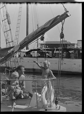 Waterfront, man and children on boat, Tahiti