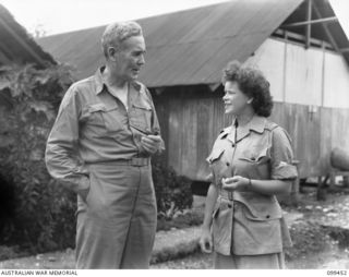 LAE, NEW GUINEA, 1945-12-25. THE RIGHT HONOURABLE J. B. CHIFLEY, PRIME MINISTER OF AUSTRALIA TALKING TO SERGEANT PRITCHARD, AUSTRALIAN WOMEN'S ARMY SERVICE (AWAS), THE ONLY WOMAN INTERPRETER OF ..