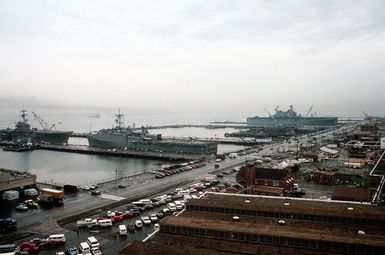 The amphibious assault ship USS INCHON (LPH-12), left, the amphibious transport dock USS PONCE (LPD-15), center, and the amphibious assault ship USS SAIPAN (LHA-2) lie tied up at the naval station