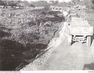 MADANG, NEW GUINEA. 1944-08-15. A SECTION OF A CONVOY OF SOME 57 TRUCKS FROM THE 165TH GENERAL TRANSPORT COMPANY AT GUM VILLAGE WHERE THEY ARE TO PICK UP SOME 2000 NATIVE LABOURERS AND TRANSPORT ..