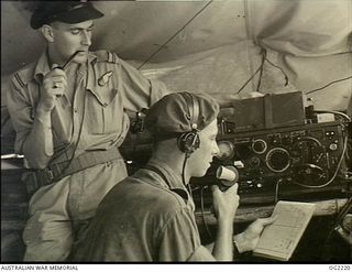 TOROKINA, BOUGAINVILLE ISLAND, SOLOMON ISLANDS. 1945-01-28. CLOSE CO-OPERATION BETWEEN AUSTRALIAN MILITARY FORCES AND RAAF IS HAVING SUCCESSFUL RESULTS. AN ARMY SIGNALLER RECEIVING FIRE ORDERS FROM ..