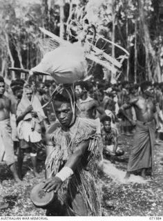 SONG RIVER, FINSCHHAFEN AREA, NEW GUINEA. 1944-03-26. THE AEROPLANE HEADDRESS WORN DURING THE SING-SING HELD BY NATIVES IN THE AUSTRALIAN NEW GUINEA ADMINISTRATIVE UNIT COMPOUND TO CELEBRATE RE ..