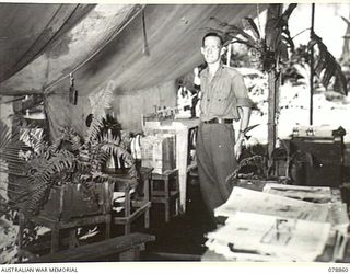 TOROKINA, BOUGAINVILLE ISLAND. 1945-02-04. SX10738 WARRANT OFFICER II, R.C. BILLS, DENTAL MECHANIC, IN THE WAITING ROOM OF THE 63RD DENTAL UNIT