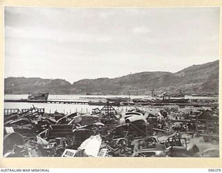 RABAUL, NEW BRITAIN, 1945-09-10. ALL BUILDINGS AND INSTALLATIONS AT RABAUL WERE DESTROYED DURING ALLIED AIR ATTACKS. SHOWN, THE SCENE OF DESOLATION AND DESTRUCTION IN THE WHARF AREA. TROOPS OF 4 ..