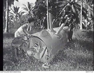 SEGI AREA, NEW GEORGIA, BRITISH SOLOMON ISLANDS PROTECTORATE. C.1944. LOCAL NATIVES WITH A FLOAT FROM A JAPANESE AIRCRAFT. (NAVAL HISTORICAL COLLECTION)