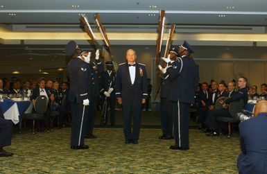 US Air Force (USAF) General (GEN) William J. Begert, Commander, Pacific Air Force (PACAF), arrives for the Order of the Sword Ceremony at the Tradewinds Enlisted Club Hickam Air Force Base (AFB), Hawaii (HI) and walks through the center of the Air Force Drill Team as they perform a drill. GEN Begert is retiring