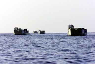 Four United States Navy Landing Craft Utility (LCUs) (1610 type) from the amphibious assault ship USS SAIPAN (LHA 2) at sea. The Saipan carries four LCUs during a deployment. Mediterranean Sea, 9 August 2000