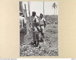 MALAGUNA MISSION, NEW BRITAIN, 1945-09-10. HALF CASTE CIVILIANS, WHO WORKED FOR THE JAPANESE PRIOR TO THEIR SURRENDER, ARRIVING AT THE BEACH-HEAD. THE AREA IS NOW OCCUPIED BY THE TROOPS OF 4 ..