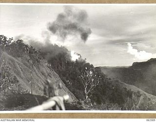 SHAGGY RIDGE, NEW GUINEA. 1943-12-27. 500 POUNDER BOMBS DROPPED FROM UNITED STATES ARMY FIGHTER AIRCRAFT EXPLODING ON JAPANESE POSITIONS ON THE "PIMPLE" DURING THE 2/16TH AUSTRALIAN INFANTRY ..