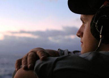US Navy (USN) SEAMAN (SN) Andrew Horner stands watch aboard the USN Nimitz Class Aircraft Carrier USS RONALD REAGAN (CVN 76) as their ship gets underway from Naval Station (NS) Pearl Harbor, Hawaii (HI), after a port visit. The REAGAN and USN Carrier Air Wing 14 (CVW-14) are completing a deployment in support of the Global War On Terrorism (GWOT) and Maritime Security Operations (MSO) in the Pacific Ocean
