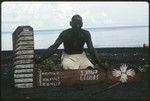 Man with writing on wooden boards