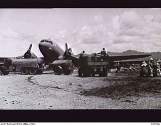 LAE, NEW GUINEA. 1943-10-11. A DOUGLAS TRANSPORT AIRCRAFT BEING REFUELLED ON THE AIRSTRIP