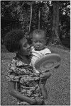 Woman with infant holding a flying disc