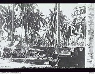 MADANG, NEW GUINEA. 1944-06-15. THE ROAD LEADING OUT OF THE MOTOR TRANSPORT SECTION, HEADQUARTERS, 15TH INFANTRY BRIGADE. THE UNIT IS AT PRESENT LOCATED AT SIAR PLANTATION