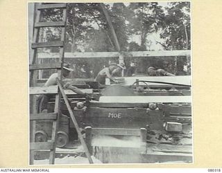 BUSU FOREST, LAE AREA, NEW GUINEA. 1944-07-26. A PORTABLE SAW MILL OPERATING AT THE 2/3RD FORESTRY COMPANY, ROYAL AUSTRALIAN ENGINEERS