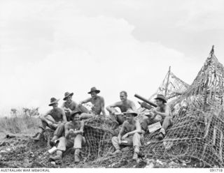 WOM, WEWAK AREA, NEW GUINEA. 1945-05-09. A GUN CREW FROM D TROOP, 2 BATTERY, 2/1 FIELD REGIMENT, AT MESS DURING A LULL IN THE ATTACK ON WEWAK. IDENTIFIED PERSONNEL ARE:- SERGEANT J.T. JOHNSTONE ..