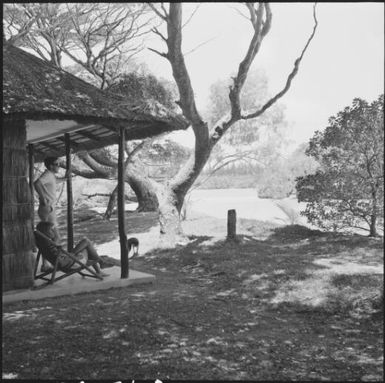 A couple and a dog outside a hut, Isle of Pines, New Caledonia, 1967 / Michael Terry