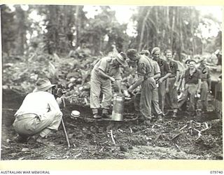 TOROKINA, BOUGAINVILLE, SOLOMON ISLANDS. 1945-03-14. MEMBERS OF THE 2/4TH ARMOURED REGIMENT, ARMOURED CORPS BEING ISSUED WITH ICE CREAM, (NORMALLY SUPPLIED ONLY TO HOSPITAL PATIENTS). IDENTIFIED ..